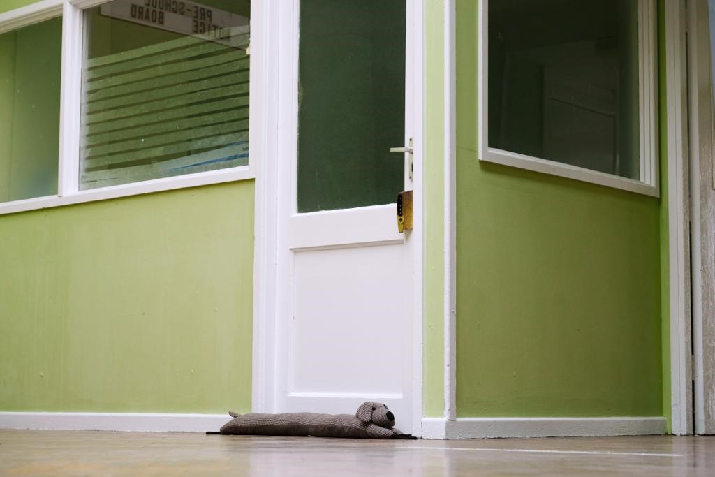 Draught excluder positioned at the door to Lark Lane Community Centre, Liverpool