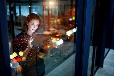 599104836 Cropped shot of a young businesswoman working late on a digital tablet in an office