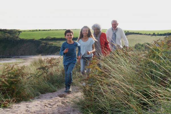 Family walking in sand dunes