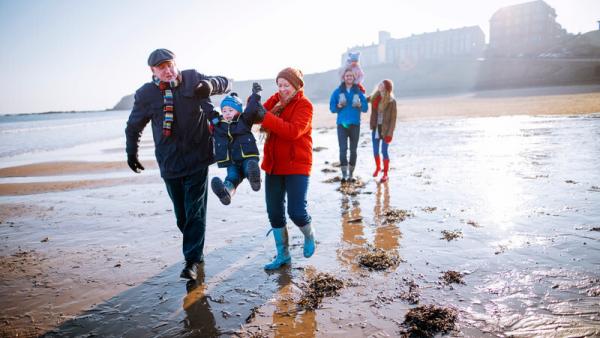 Image of a family walking on a beach