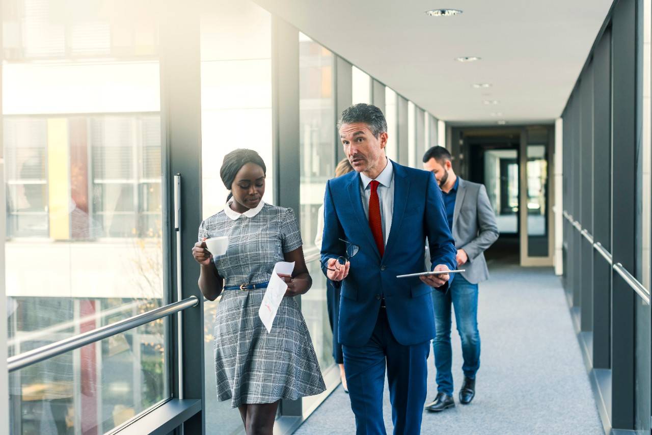 Image of two colleagues walking side by side.