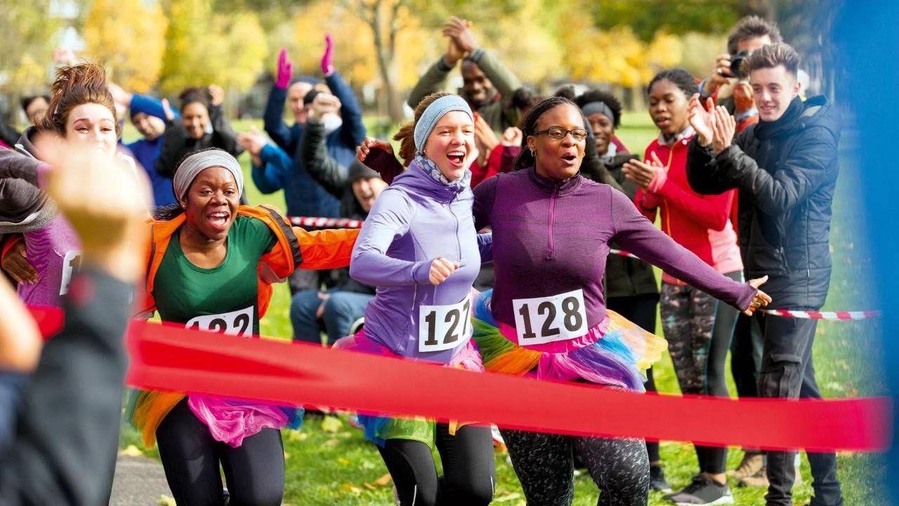 Image of 3 runners finishing a charity race.