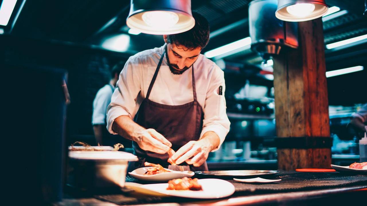 Image of chef preparing food in the hospitality sector.