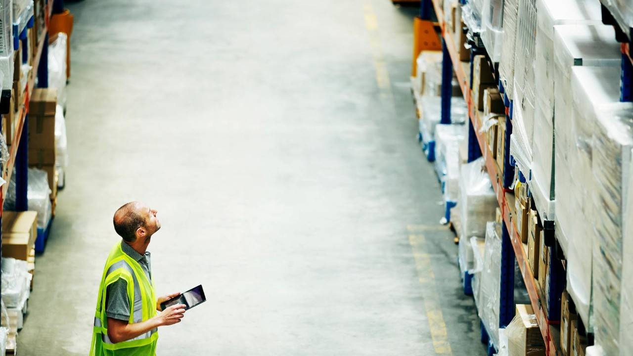 Image of a worker accessing retail stock.